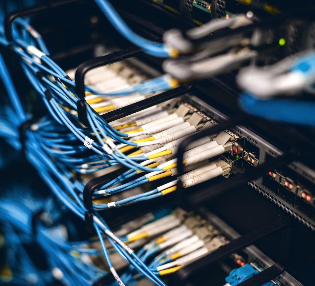 Fiber optic patch cables connected to a rack-mounted network switch